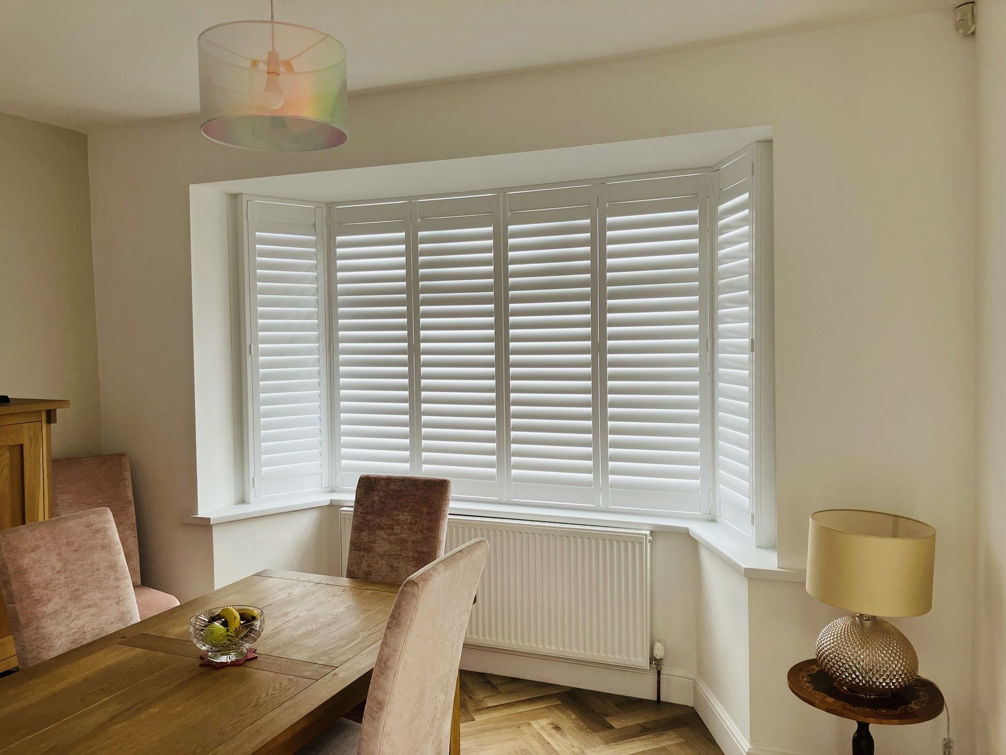 Bay window plantation shutters fitted in a Suffolk home